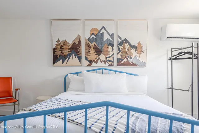 a view of a room that has a bed and a window