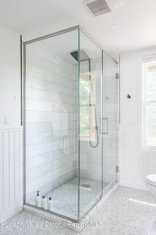 a bathroom with a glass shower door