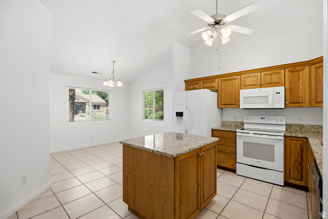 1630 East 2450th Street South, Unit 263 St. George, UT 84790 - Photo 4 of 24 Kitchen featuring wood cabinetry, light-toned countertops, white appliances, and a central island