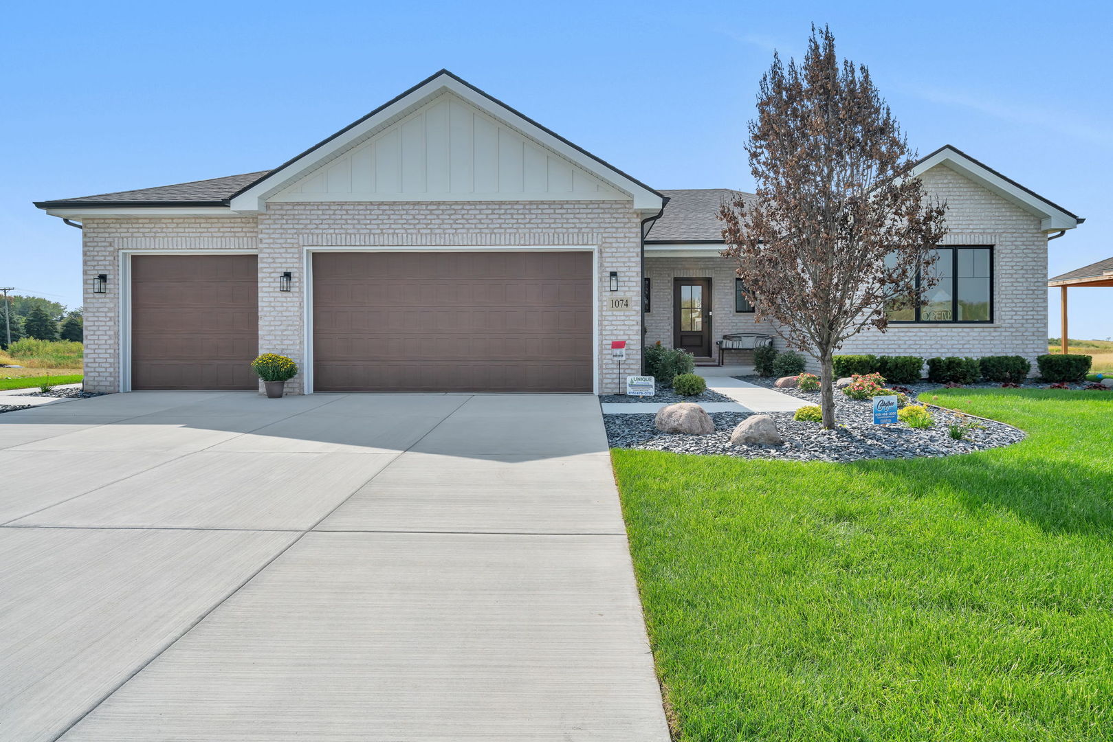1074 Kinley Drive New Lenox, IL 60451 - Photo 2 of 37 a front view of a house with garden