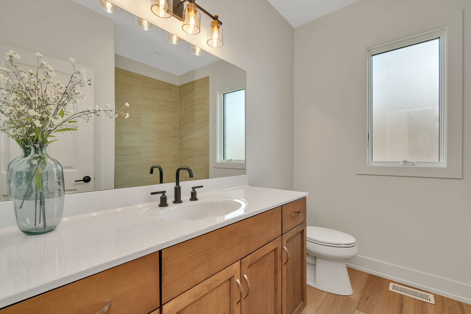 1074 Kinley Drive New Lenox, IL 60451 - Photo 24 of 37 a bathroom with a sink a toilet and mirror