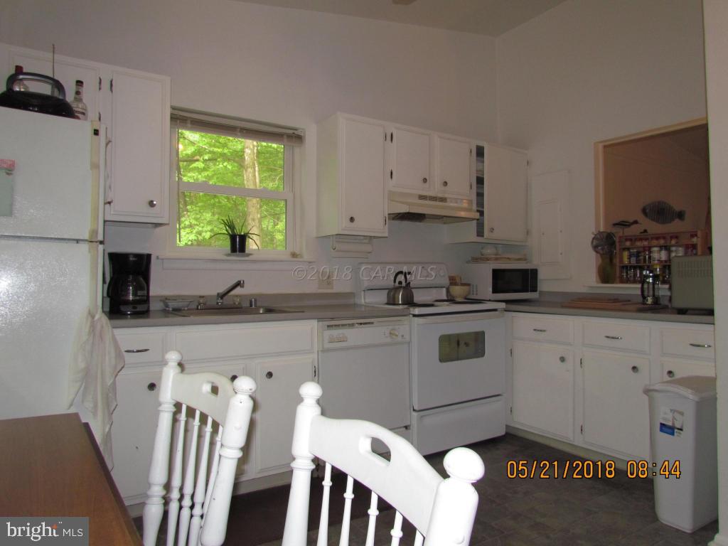 38 Sandyhook Road Ocean Pines, MD 21811 - Photo 13 of 33 a kitchen with stainless steel appliances granite countertop a stove a sink a microwave a refrigerator and white cabinets