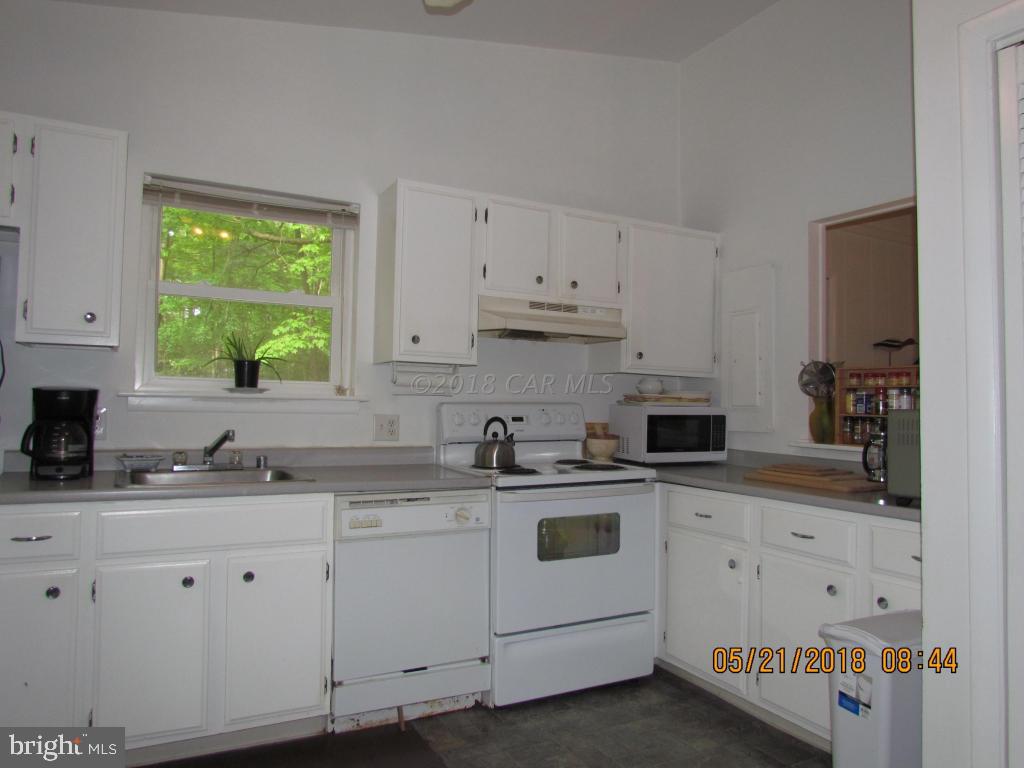 38 Sandyhook Road Ocean Pines, MD 21811 - Photo 14 of 33 a kitchen with cabinets appliances a sink and a window