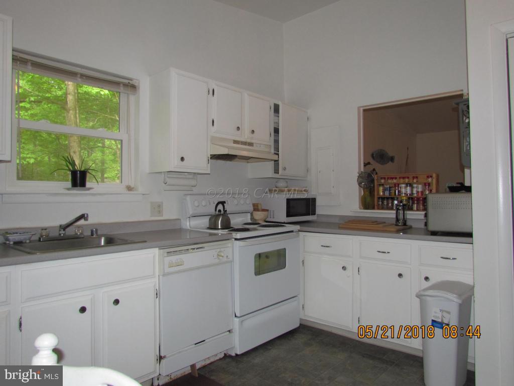 38 Sandyhook Road Ocean Pines, MD 21811 - Photo 15 of 33 a kitchen with granite countertop a sink a stove and cabinets