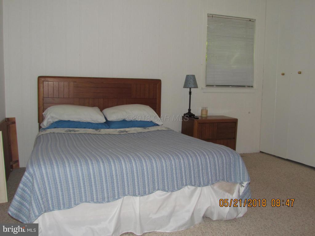 38 Sandyhook Road Ocean Pines, MD 21811 - Photo 18 of 33 a bedroom with a bed and a night stand