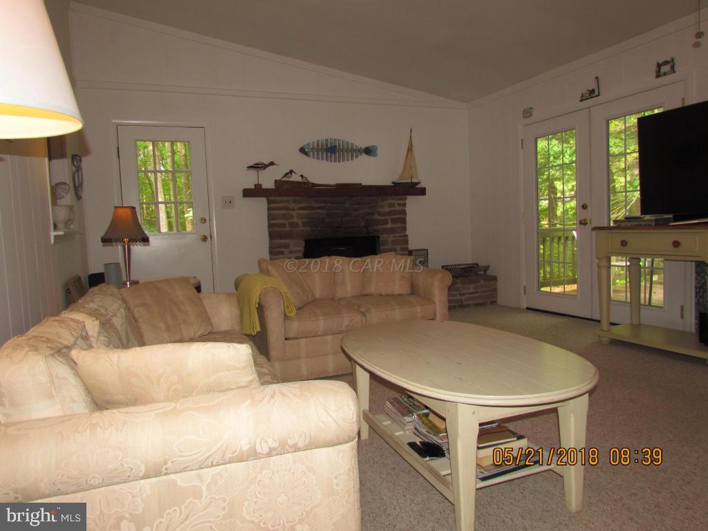 38 Sandyhook Road Ocean Pines, MD 21811 - Photo 3 of 33 a living room with furniture and a flat screen tv
