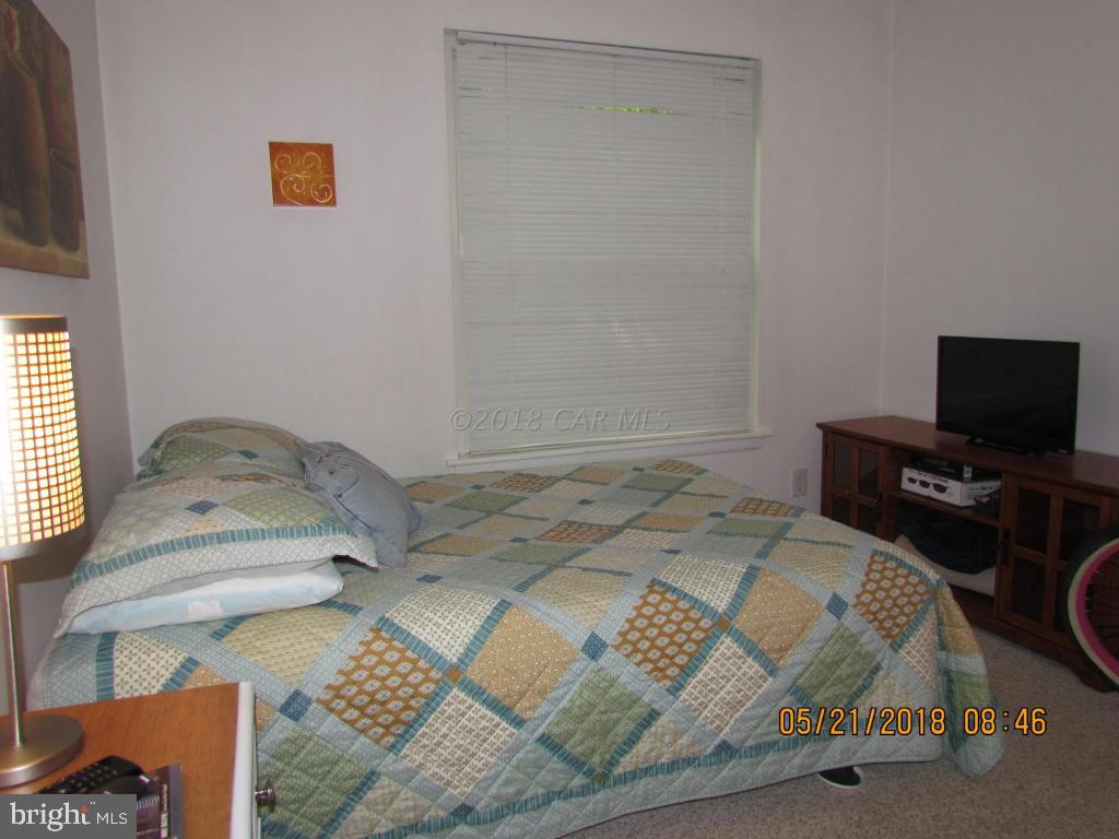 38 Sandyhook Road Ocean Pines, MD 21811 - Photo 21 of 33 a bedroom with a bed and flat screen tv