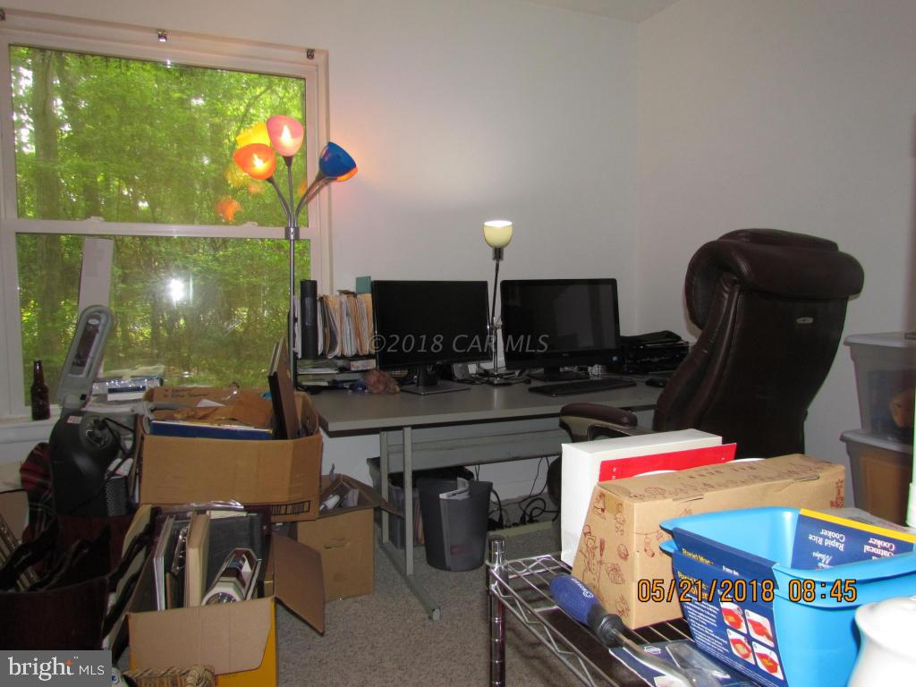 38 Sandyhook Road Ocean Pines, MD 21811 - Photo 24 of 33 a room with furniture a flat screen tv and a floor to ceiling window