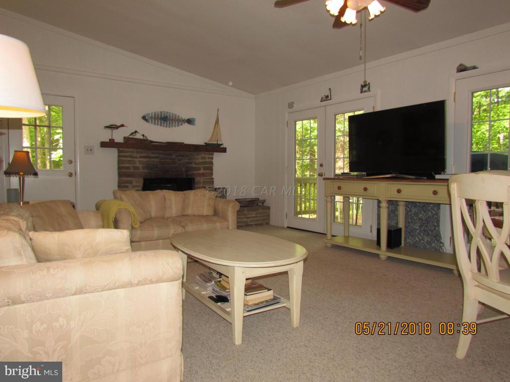 38 Sandyhook Road Ocean Pines, MD 21811 - Photo 4 of 33 a living room with furniture and a flat screen tv