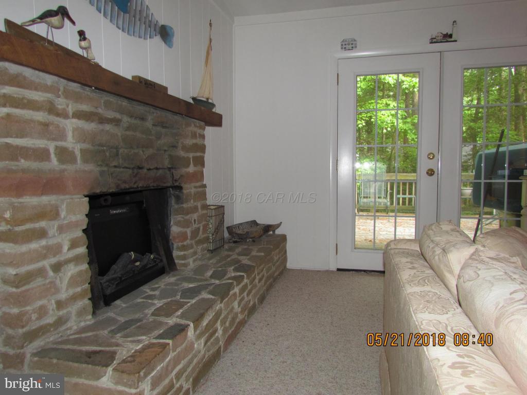 38 Sandyhook Road Ocean Pines, MD 21811 - Photo 7 of 33 a living room with furniture and a fireplace