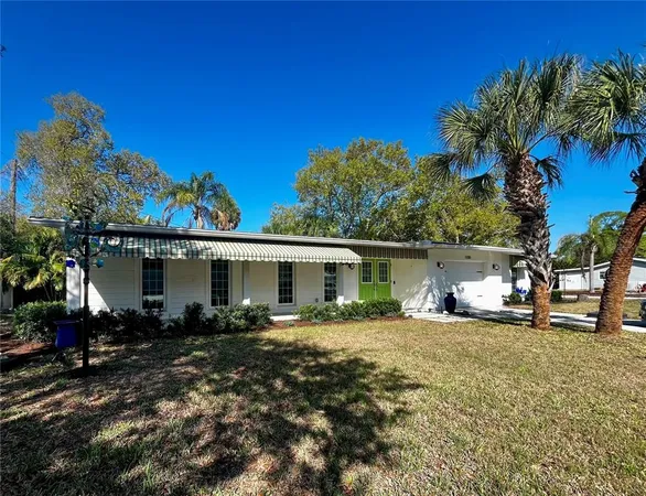 a view of a house with backyard sitting area and garden
