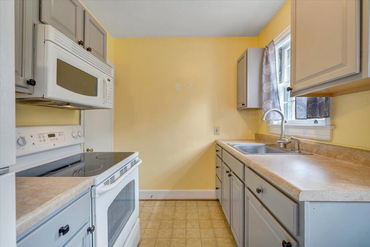 910 Brandon Avenue Southwest Roanoke, VA 24015 - Photo 12 of 50 a kitchen with a sink and a stove top oven