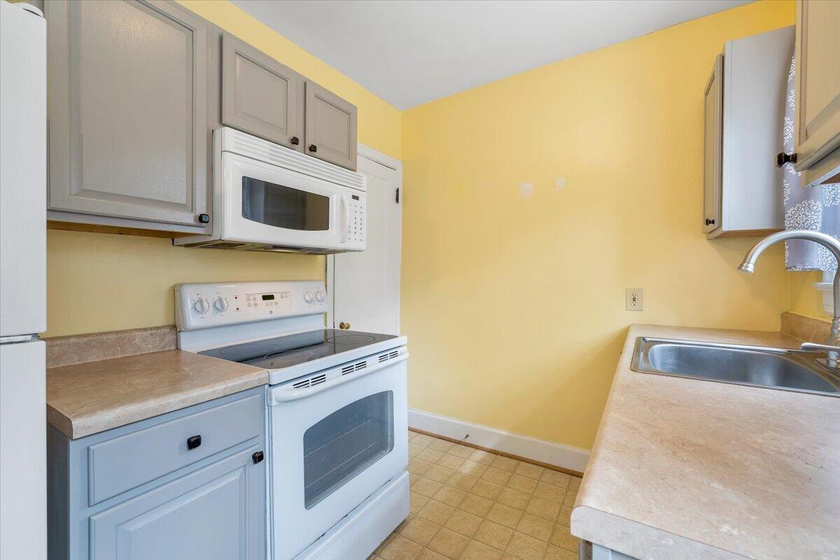 910 Brandon Avenue Southwest Roanoke, VA 24015 - Photo 13 of 50 a kitchen with stainless steel appliances granite countertop a sink and a stove