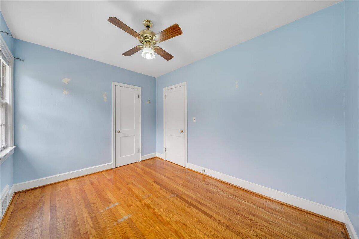 910 Brandon Avenue Southwest Roanoke, VA 24015 - Photo 16 of 50 a view of a big room with wooden floor and a ceiling fan