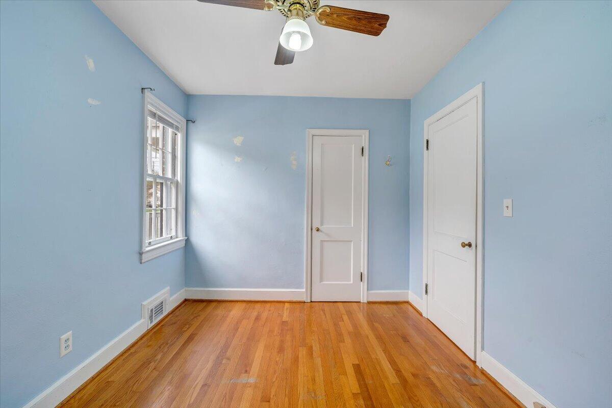 910 Brandon Avenue Southwest Roanoke, VA 24015 - Photo 17 of 50 a view of empty room with wooden floor and fan