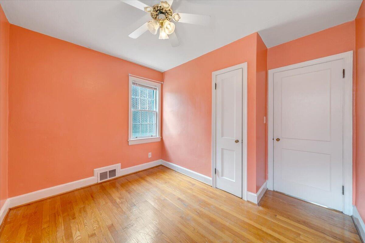 910 Brandon Avenue Southwest Roanoke, VA 24015 - Photo 19 of 50 a view of an empty room with wooden floor and a window