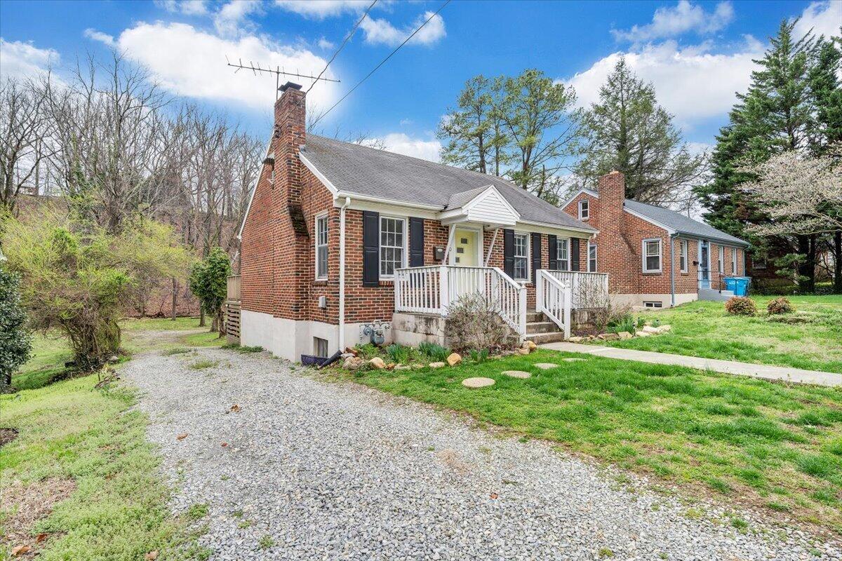 910 Brandon Avenue Southwest Roanoke, VA 24015 - Photo 2 of 50 a front view of a house with a yard and garage