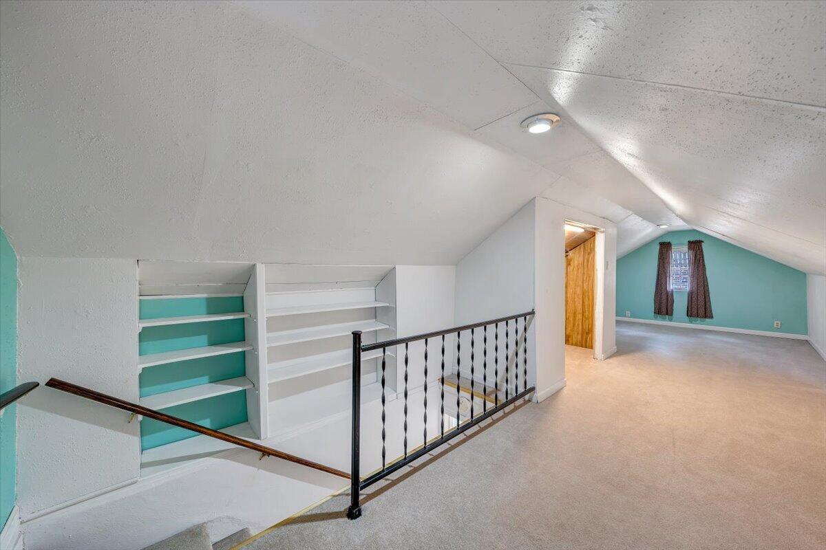 910 Brandon Avenue Southwest Roanoke, VA 24015 - Photo 23 of 50 a view of a hallway with stairs and a chandelier