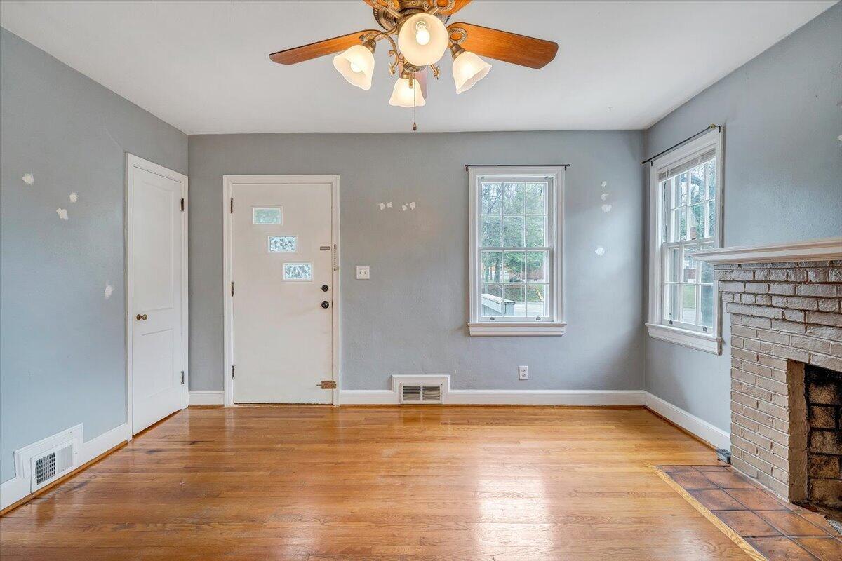 910 Brandon Avenue Southwest Roanoke, VA 24015 - Photo 3 of 50 a view of an empty room with window and wooden floor