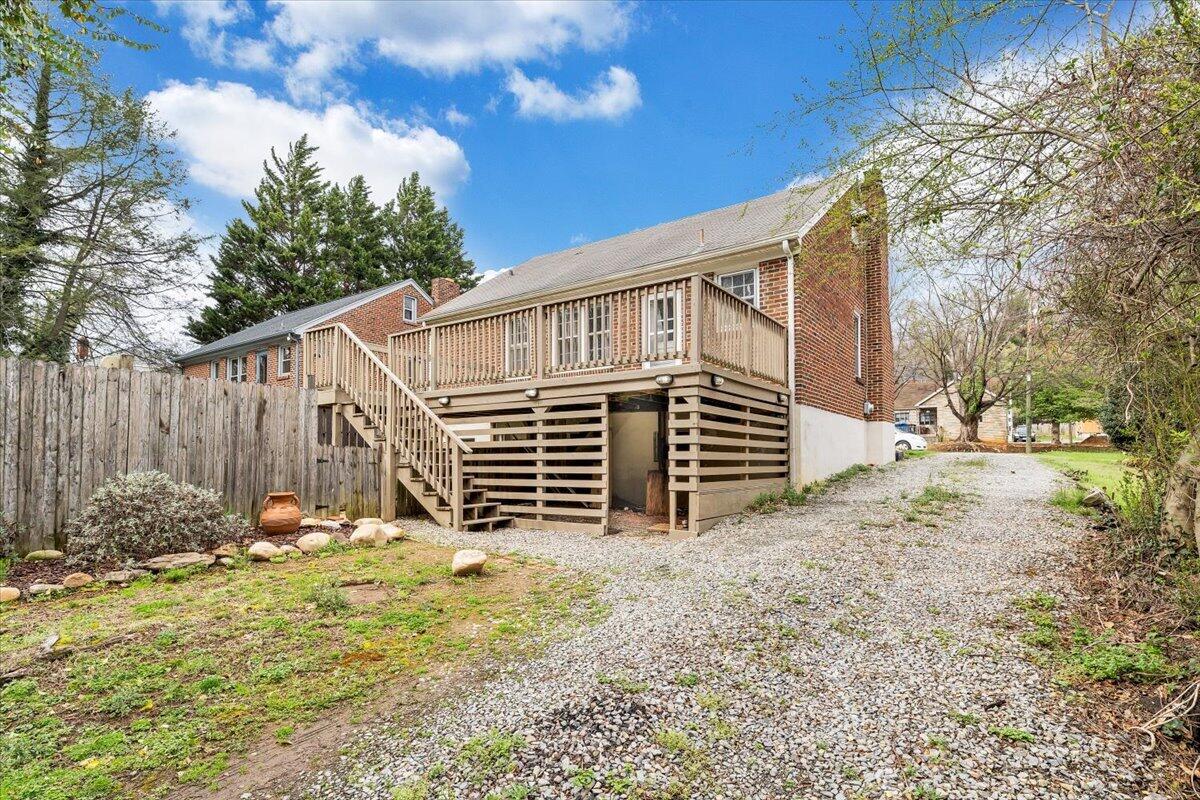 910 Brandon Avenue Southwest Roanoke, VA 24015 - Photo 40 of 50 a backyard of a house with wooden fence and a tree