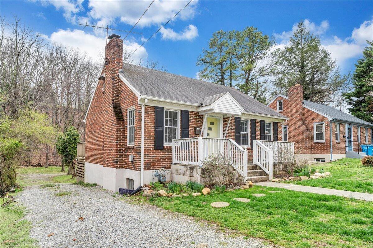 910 Brandon Avenue Southwest Roanoke, VA 24015 - Photo 46 of 50 a front view of a house with a garden and yard