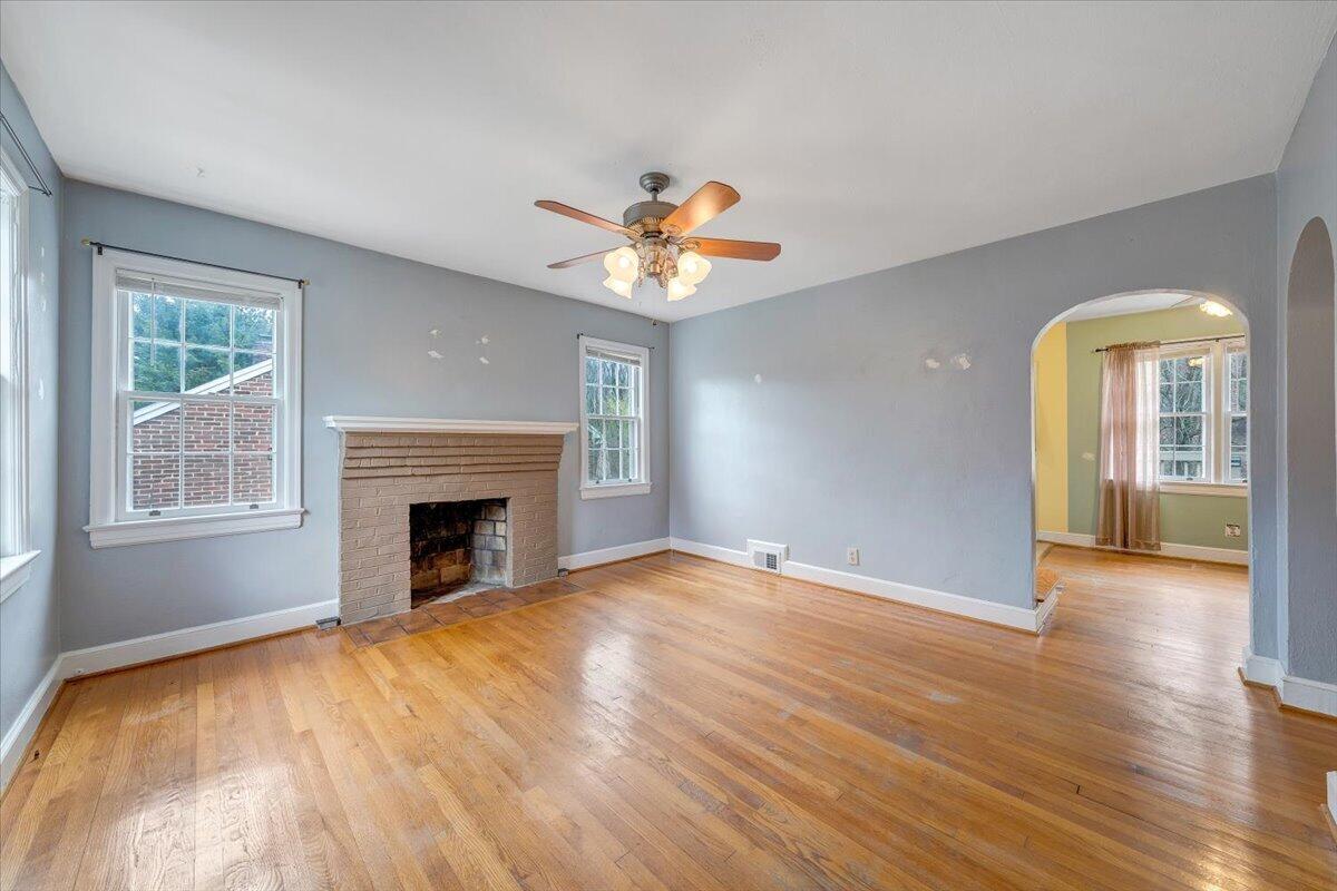 910 Brandon Avenue Southwest Roanoke, VA 24015 - Photo 5 of 50 a view of an empty room with window and wooden floor