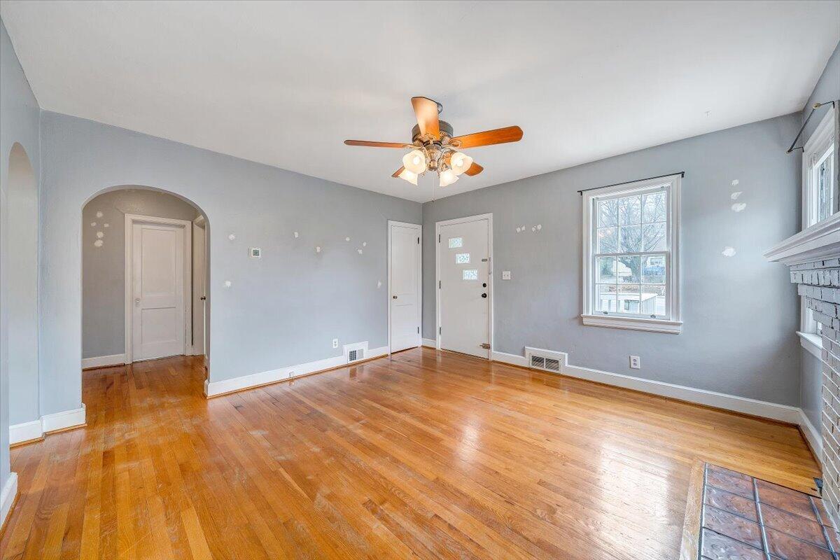 910 Brandon Avenue Southwest Roanoke, VA 24015 - Photo 6 of 50 a view of an empty room with window and wooden floor