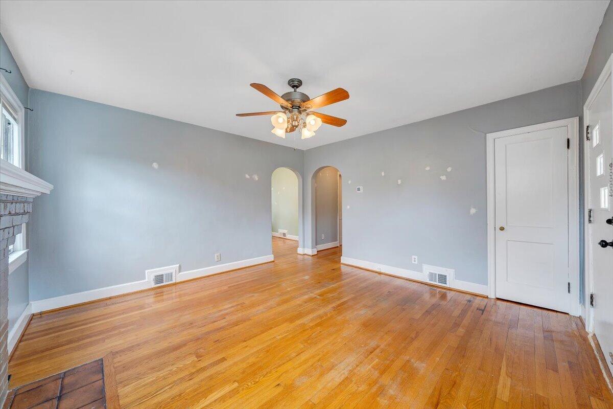 910 Brandon Avenue Southwest Roanoke, VA 24015 - Photo 7 of 50 a view of an empty room with window and wooden floor