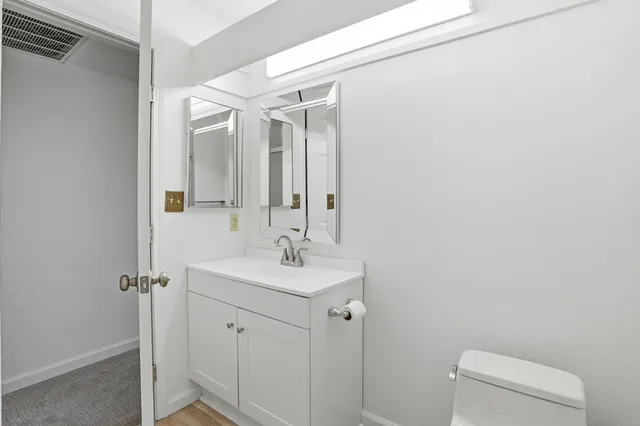 a bathroom with mirror a sink and vanity