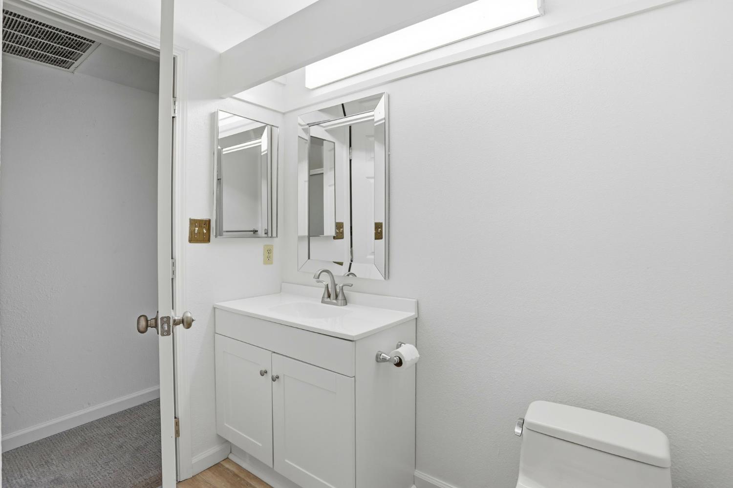 152 Hackamore Lane Fremont, CA 94539 - Photo 21 of 32 a bathroom with a toilet sink vanity and mirror