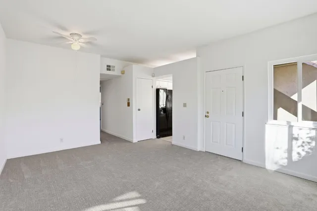 an empty room with windows and closet