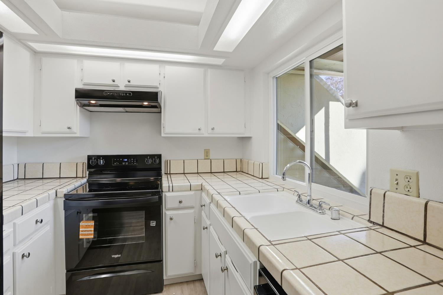 152 Hackamore Lane Fremont, CA 94539 - Photo 8 of 32 a kitchen with a sink stove and cabinets