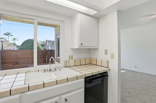 an empty room with a window and a ceiling fan