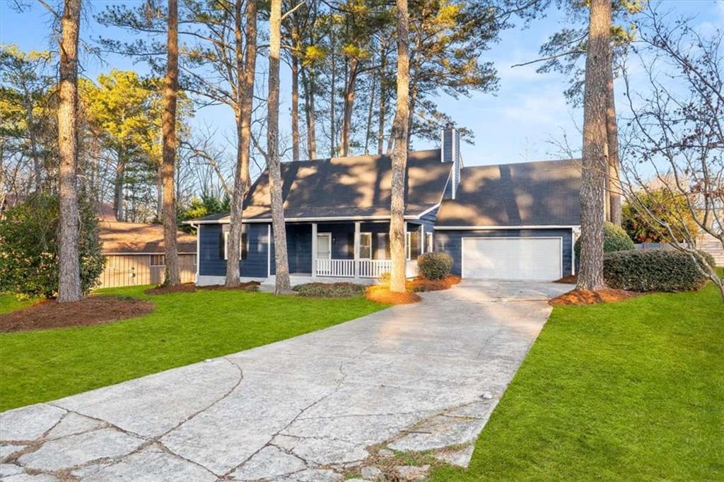 a front view of house with yard and trees