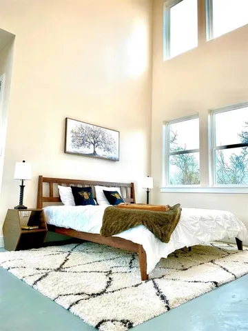 a bedroom with a bed and a window