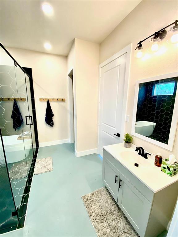 4302 Fm 2862, Unit B Anna, TX 75409 - Photo 7 of 13 a bathroom with a tub sink and mirror