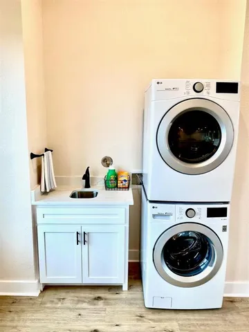 a utility room with sink dryer and washer