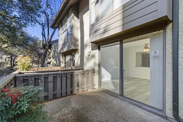 a view of a house with a wooden deck