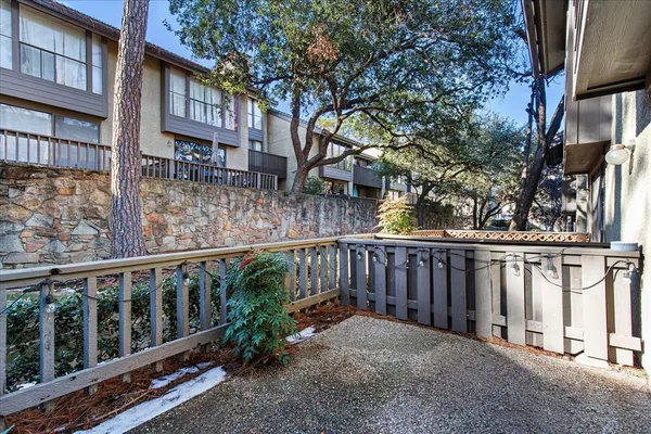 a view of a brick house with a wooden fence