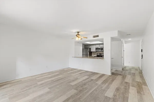 a view of a kitchen with a sink and a refrigerator