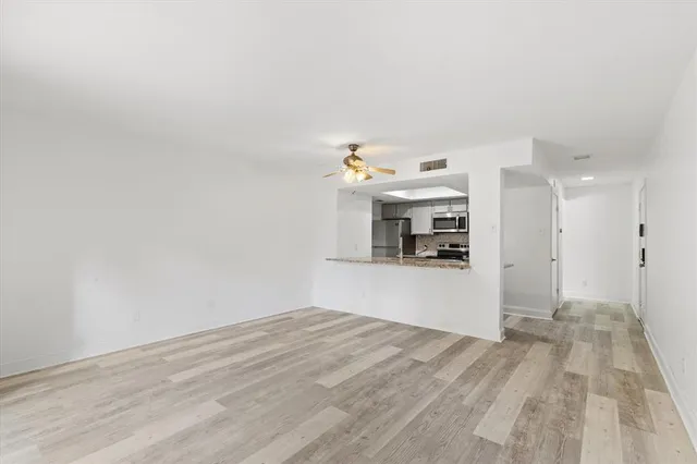 a view of a kitchen with a sink and a refrigerator