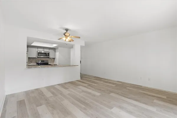 a view of a kitchen with a sink and a chandelier