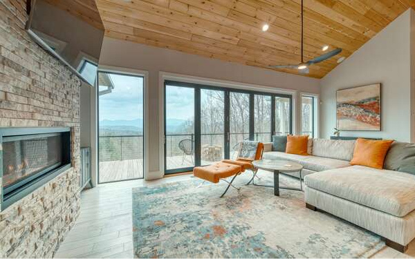 740 Chestnut Mountain Road Blairsville, GA 30512 - Photo 11 of 75 a living room with furniture a flat screen tv and a fireplace