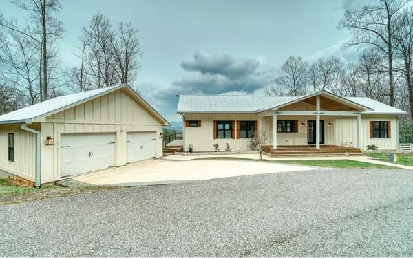 740 Chestnut Mountain Road Blairsville, GA 30512 - Photo 15 of 75 a front view of a house with a yard and garage