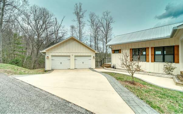 740 Chestnut Mountain Road Blairsville, GA 30512 - Photo 17 of 75 a front view of a house with a yard and potted plants