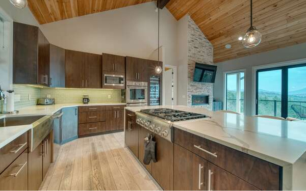 740 Chestnut Mountain Road Blairsville, GA 30512 - Photo 19 of 75 a kitchen with a stove a sink a refrigerator and cabinets