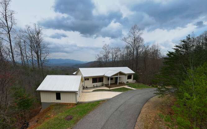 740 Chestnut Mountain Road Blairsville, GA 30512 - Photo 22 of 75 a aerial view of a house with table and chairs under an umbrella