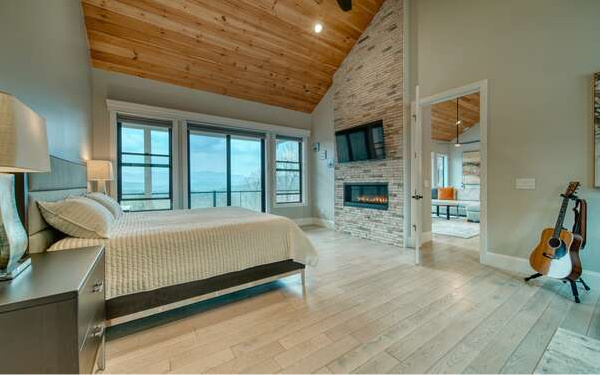 740 Chestnut Mountain Road Blairsville, GA 30512 - Photo 25 of 75 a bed sitting in a spacious bedroom next to a window