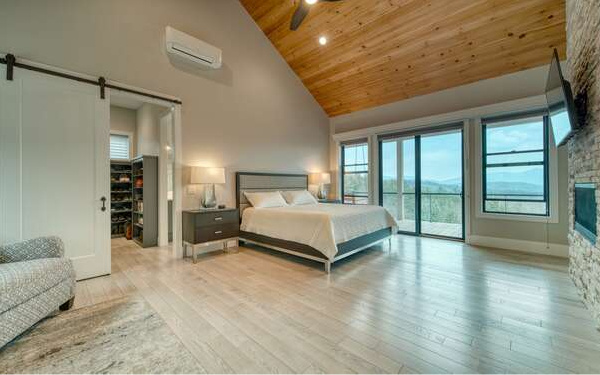 740 Chestnut Mountain Road Blairsville, GA 30512 - Photo 26 of 75 a bedroom with a large bed and a large window