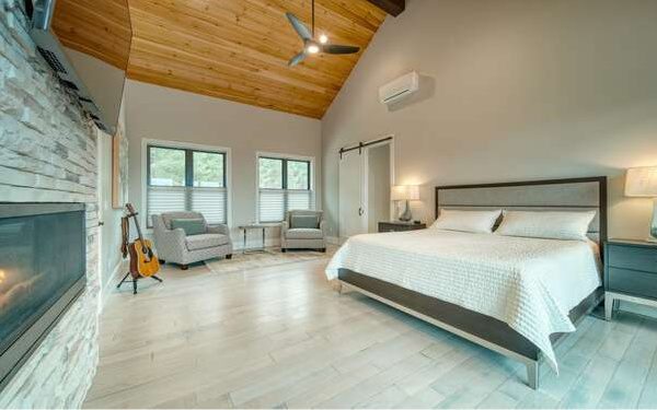 740 Chestnut Mountain Road Blairsville, GA 30512 - Photo 27 of 75 a bedroom with furniture and a fireplace